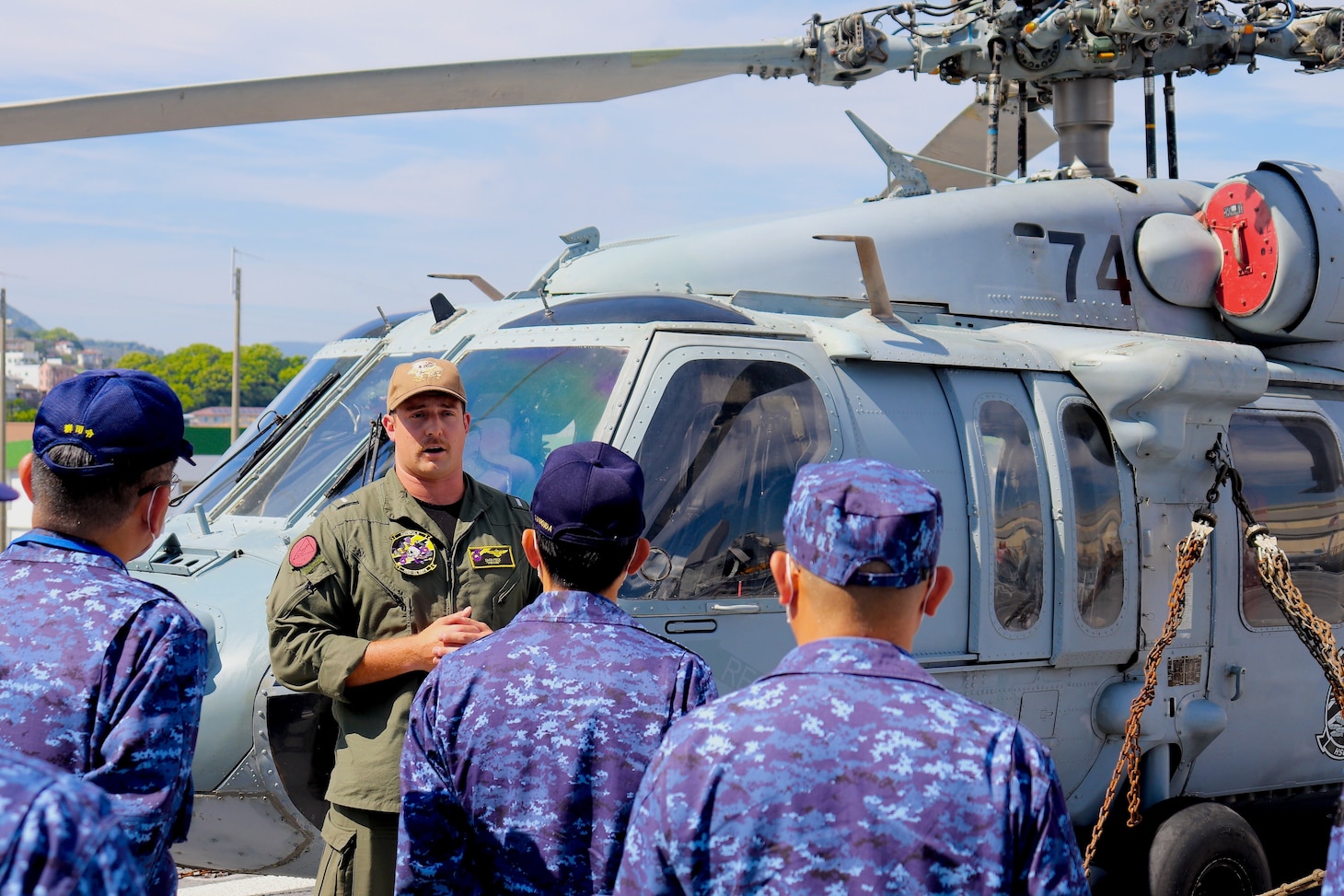 SASEBO, Japan (June 1, 2022) Lt. Zach Peck, from Windsor, Colorado, describes to Japan Maritime Self-Defense Force officers the role of an MH-60S Sea Hawk helicopter in the mine warfare mission set assigned to the Independence-class littoral combat ship USS Charleston (LCS 18). Charleston, part of Destroyer Squadron (DESRON) 7, is on a rotational deployment, operating in the U.S. 7th Fleet area of operations to enhance interoperability with partners and serve as a ready-response force in support of a free and open Indo-Pacific region. (U.S. Navy photo by Lt. j.g. James French)