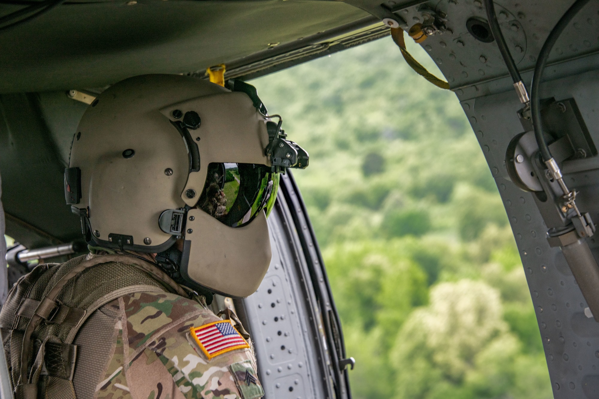 soldier flies in helicopter