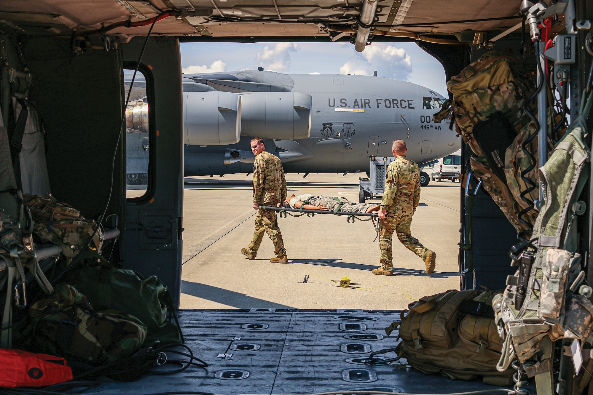 West Virginia Army National Guard Charlie Company 2nd General Support Battalion 104th Aviation Regiment soldiers transport a mock patient to a C-17 Globemaster III during training with the 445th Airlift Wing and the U.S. Air Force School of Aerospace Medicine May 14, 2022.