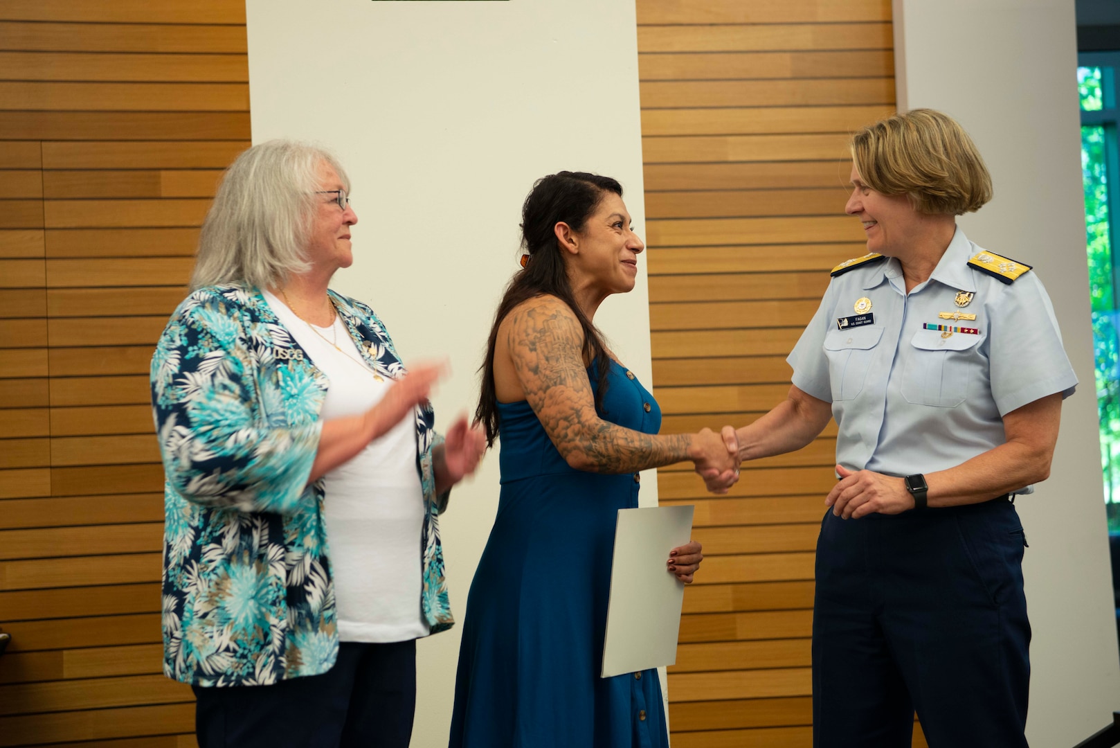 U.S. Coast Guard spouse Ivonne Ontiveros-Lopez (middle) receives the 2021 Wanda Allen-Yearout Ombudsman of the Year award, presented by Wanda Allen-Yearout, herself, (left) and Adm. Linda Fagan, Coast Guard commandant, (right) at the Senior Leadership Conference at Coast Guard Headquarters in Washington, D.C., June 2, 2022.
The Wanda Allen-Yearout OOY Award Program annually recognizes a unit ombudsman that has demonstrated the greatest commitment serving as a Coast Guard Ombudsman.
(U.S. Coast Guard photo by Petty Officer 2nd Class Ronald Hodges)