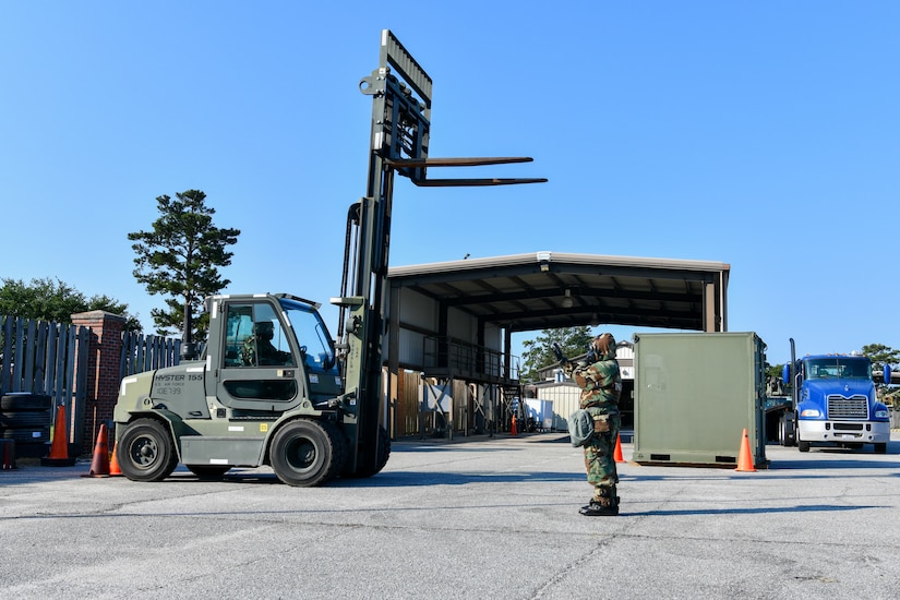 U.S. Air Force Airman 1st Class Ashlyn Martin, 628th Logistics Readiness Squadron Supply apprentice, guides Staff Sgt. Jade McKeirnan, 628th LRS Individual Protective Equipment supervisor, through safety checks during forklift training at Joint Base Charleston, South Carolina, June 2, 2022.