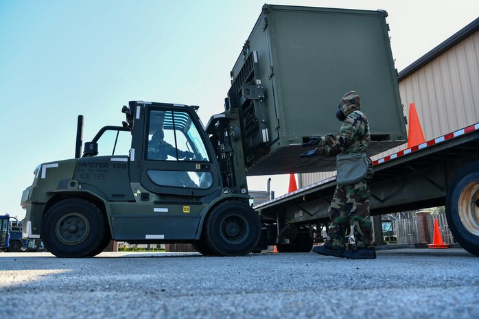 U.S. Air Force Staff Sgt. Jade McKeirnan directs Airman 1st Class Ashlyn Martin
