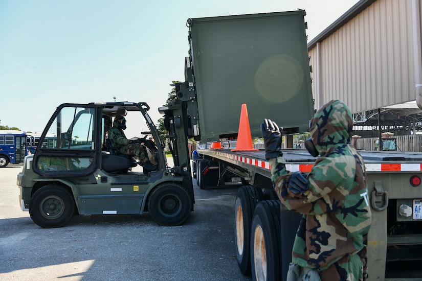 U.S. Air Force Airman 1st Class Jaron Stamper guides Staff Sgt. Zachary Jones