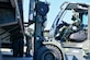 U.S. Air Force Staff Sgt. Zachary Jones directs Airman 1st Class Jaron Stamper to safely set down a container during forklift training