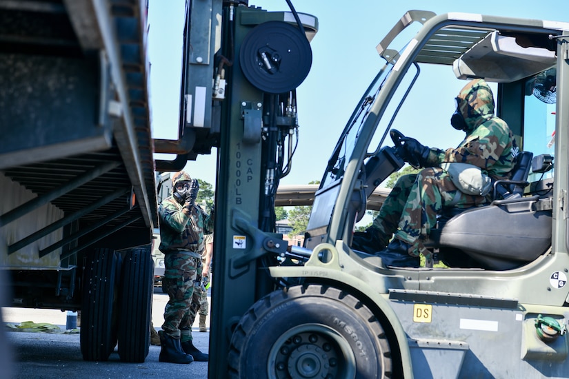 U.S. Air Force Staff Sgt. Zachary Jones, 437th Operation Support Squadron Flight Line Operations craftsman, directs Airman 1st Class Jaron Stamper, 628th Logistics Readiness Squadron Individual Protective Equipment journeyman, to safely set down a container during forklift training at Joint Base Charleston, South Carolina, June 2, 2022.