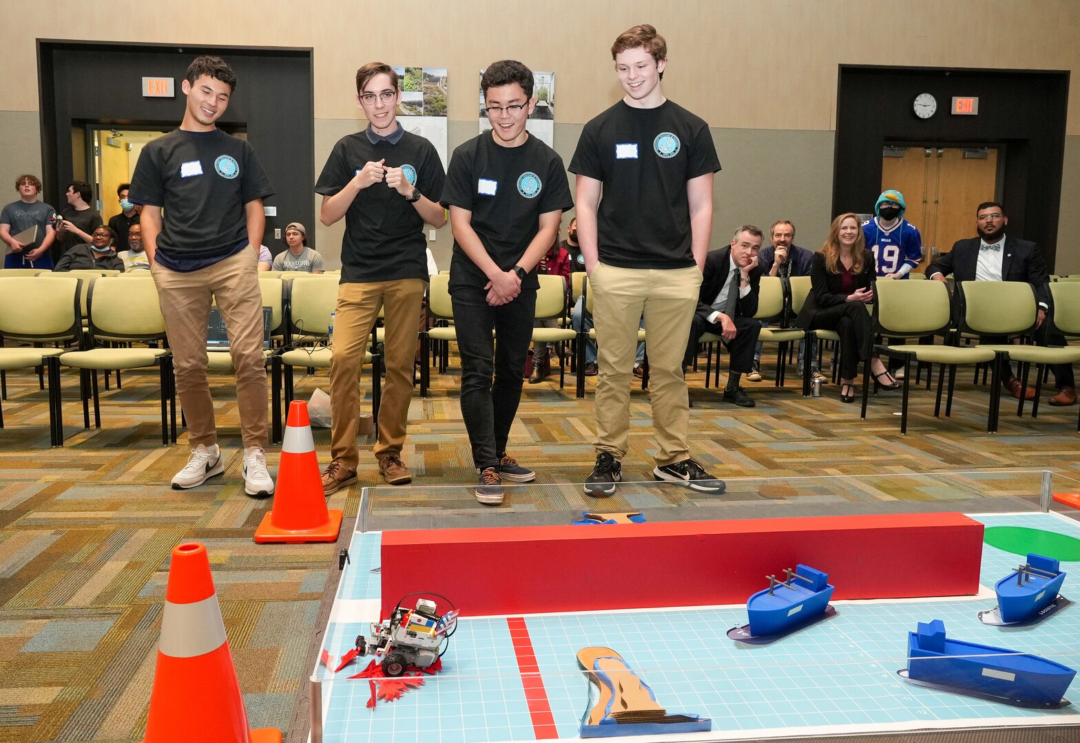 IMAGE: Fredericksburg Christian School (FCS) teammates (l to r) Gabe Ognek,Cody Cockrell, Yuki Jones and Jack Knewtson smile as their robot completes the obstacle course at the innaugural Innovation Challenge @Dahlgren. The FCS team took first place earning a $3,000 cash prize.