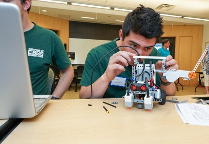IMAGE: Aaron Sweeney of the Chesapeake Bay Governor’s School (CBGS) makes adjustments to his team’s robot prior to competition at the Innovation Challenge @Dahlgren. CBGS was one of 12 schools competing for $5,000 in cash prizes.