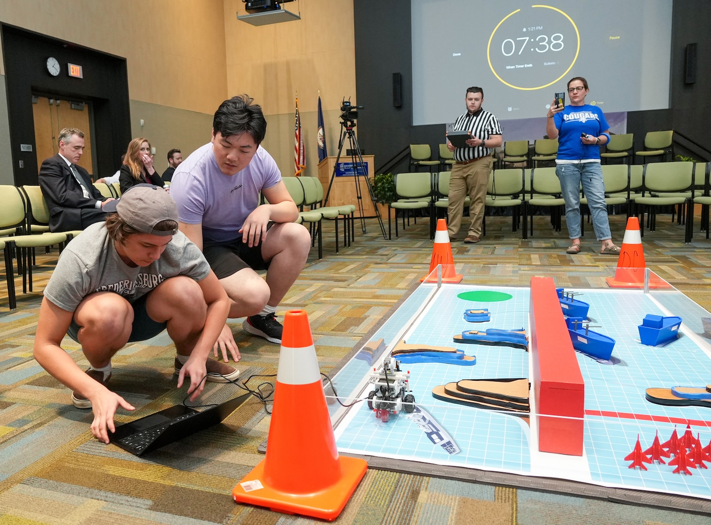 IMAGE: Courtland High School’s Nicholas Pachek, left, and Phillip Lam make coding adjustments to their robot during Innovation Challenge @Dahlgren, April 30. The robotics competition featured teams from 12 area public, private and governor’s high schools vying for a total of $5000 in cash prizes.