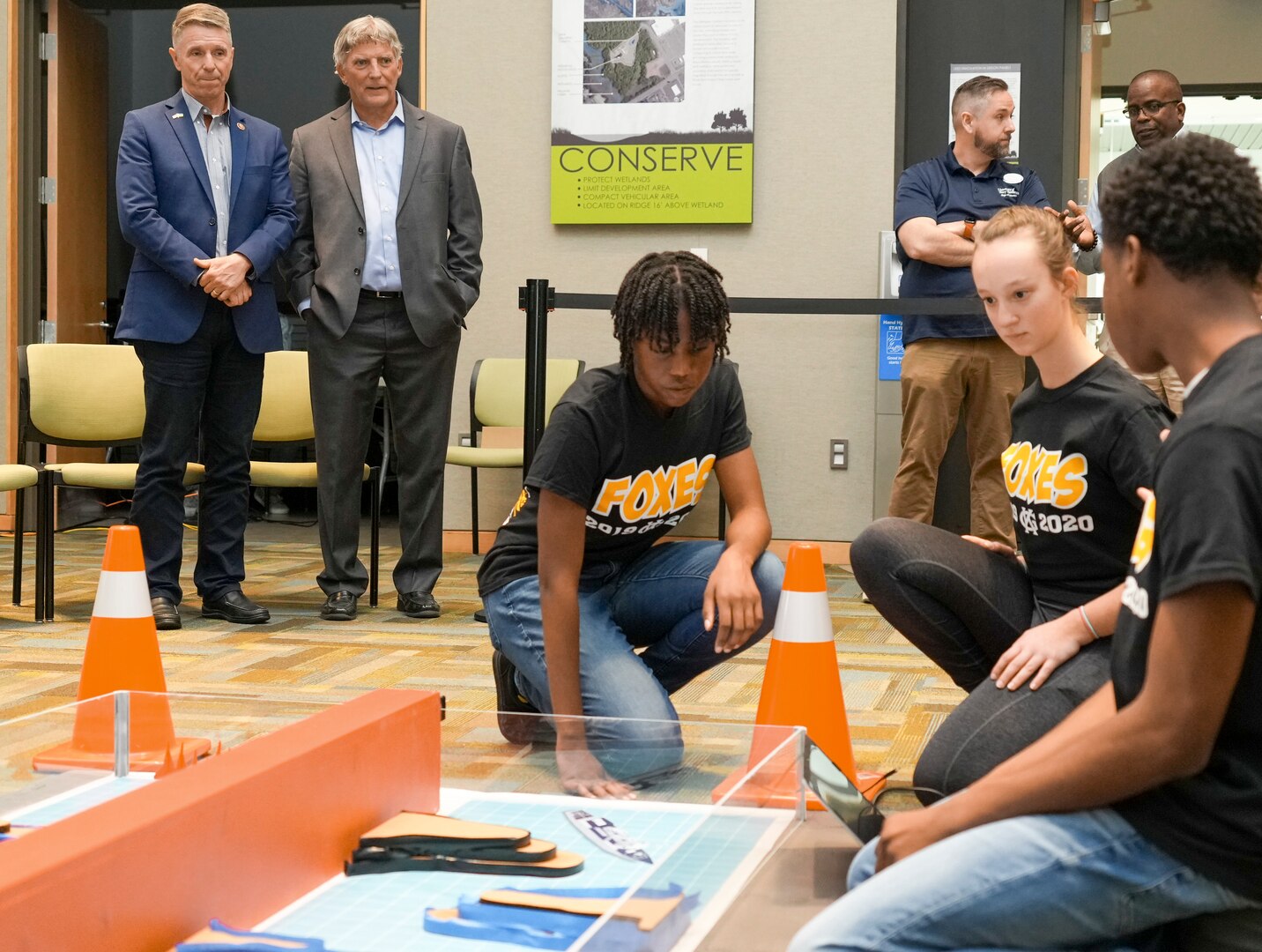 IMAGE: From left, U.S. Rep. Rob Wittman, R-Virginia, and University of Mary Washington's John Burrow watch as a team from King George High School compete in the  Innovation Challenge @Dahlgren, April 30. The robotics competition featured teams from 12 area public, private and governor’s high schools vying for a total of $5000 in cash prizes.