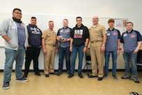 IMAGE: Vice Adm. William Galinis, third from left, Naval Surface Warfare Center Dahlgren Division Commanding Officer Capt. Philip “Phil” Mlynarski, third from right, take a picture with the North Stafford High School robotics team during the Innovation Challenge @Dahlgren. The robotics competition featured teams from 12 area public, private and governor’s high schools vying for a total of $5000 in cash prizes.