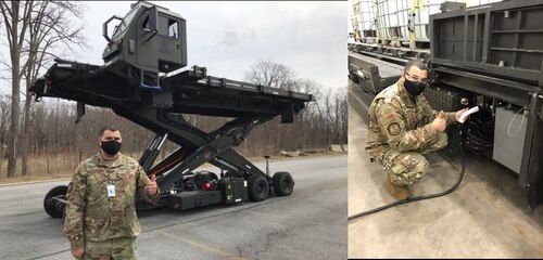 Johnstown, Pa. -- Master Sgt. Ryan Young, lead Halvorsen mechanic, 441st Vehicle Support Chain Operations Squadron, signals acceptance of the Hybrid Halvorsen prototype design, operational performance and charging interface.