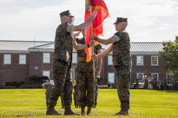 U.S. Marine Corps Brig. Gen. Michael E. McWilliams, the incoming commanding general of 2nd Marine Logistics Group, left, receives the unit colors from Brig. Gen. Forrest C. Poole III, the outgoing commanding General of 2nd Marine Logistics Group, during a change of command ceremony on Camp Lejeune, North Carolina, June 8, 2022. During the ceremony, Brig. Gen. Michael E. McWilliams assumed command of 2nd Marine Logistics Group from Brig. Gen. Forrest C. Poole III. (U.S. Marine Corps photo by Lance Cpl. Meshaq Hylton)