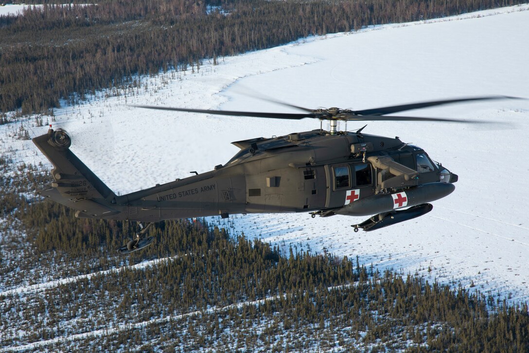 Members of the 2-211th General Aviation Support Battalion transport an HH-60M Black Hawk helicopter and a UH-60L Black Hawk helicopter to Bethel from Joint Base Elmendorf-Richardson April 11, 2022, for their annual training this spring. (Alaska National Guard photo by Victoria Granado)