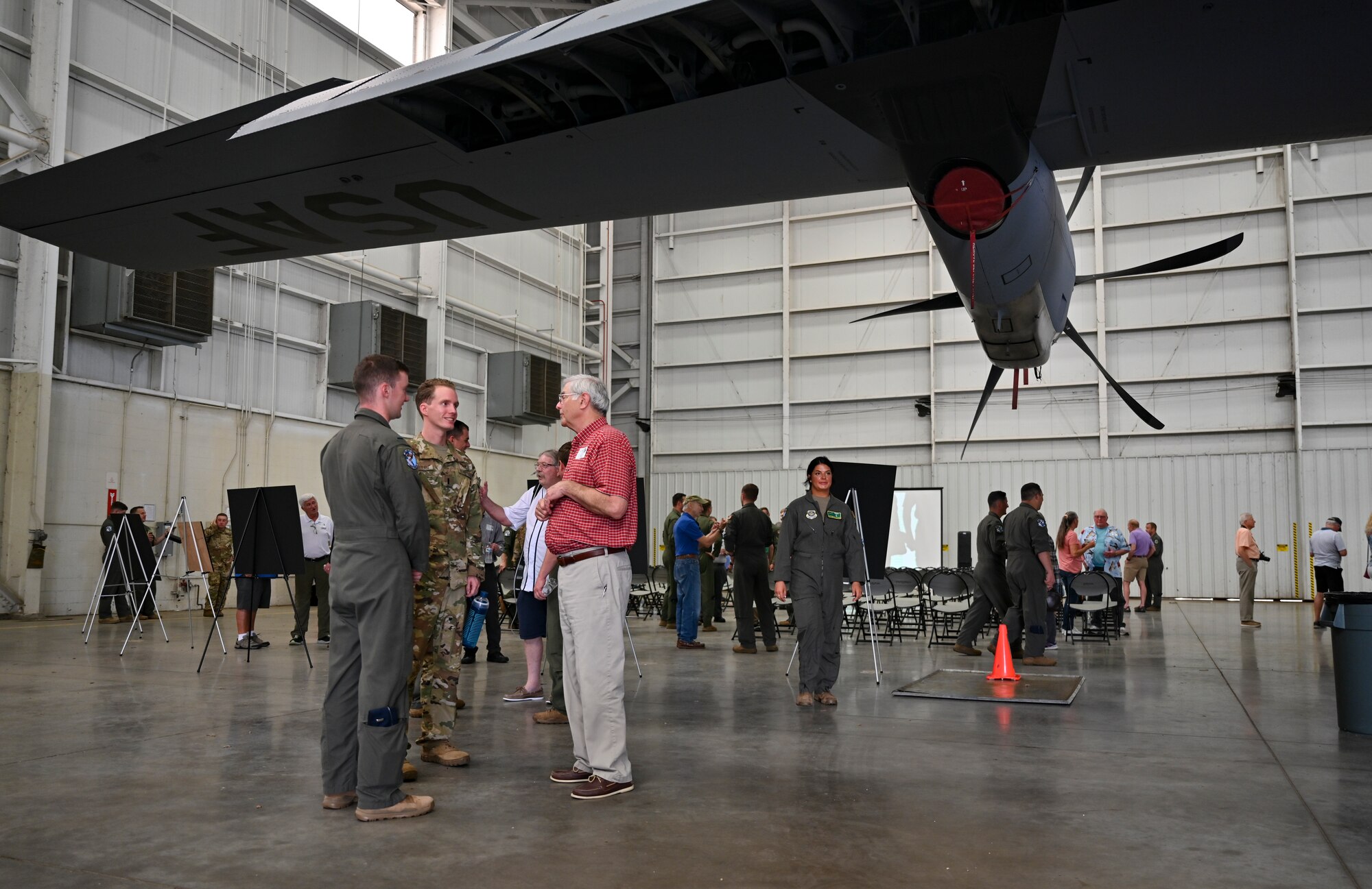 A former member of the 61st Tactical Airlift Squadron interacts with Airmen assigned to the 61st Airlift Squadron during a reunion visit