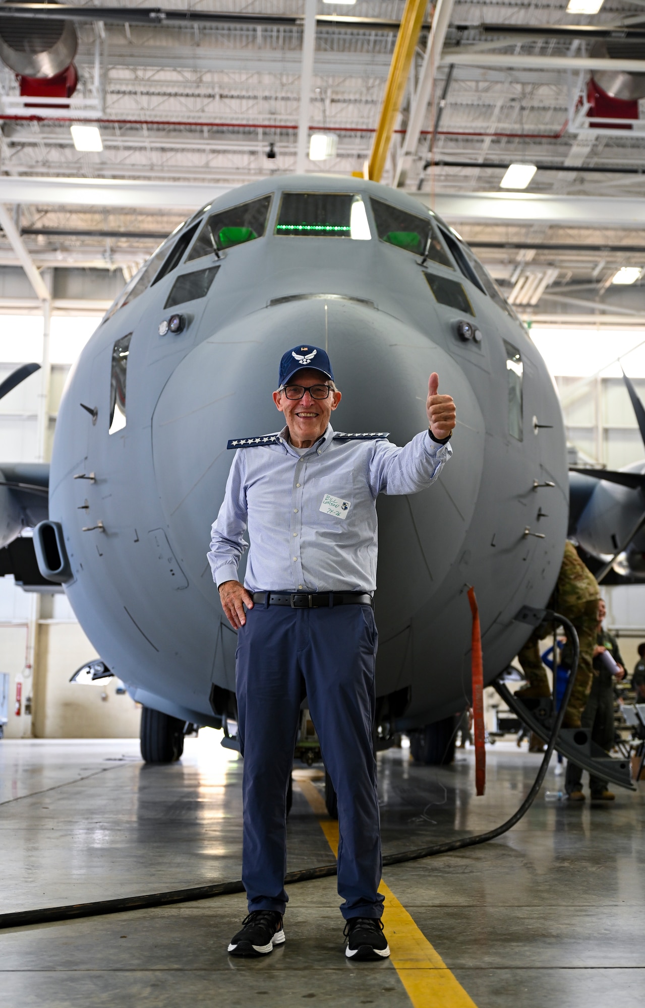 Bill London, a former member of the 61st Tactical Airlift Squadron from 1974 to 1976, poses for a photo in front of a C-130J Super Hercules