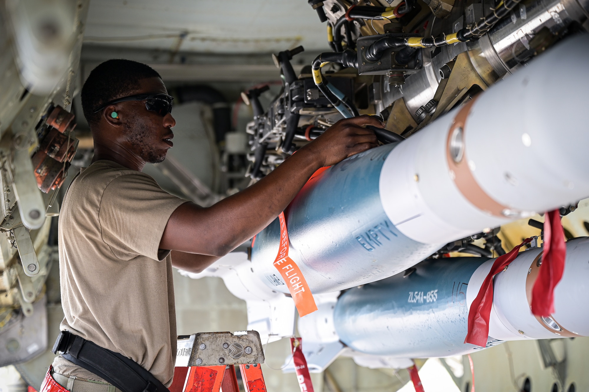 Staff Sgt. Schnathan Johnson, 96th Aircraft Maintenance Unit weapons load team chief, latches a GBU-12 munition to the bomb bay of a B-52H Stratofortress during Combat Hammer at Barksdale Air Force Base, Louisiana, June 7, 2022. Combat Hammer is a week-long evaluation of the wing’s capacity to generate, load and employ conventional weapons on target. (U.S. Air Force photo by Senior Airman Jonathan E. Ramos)