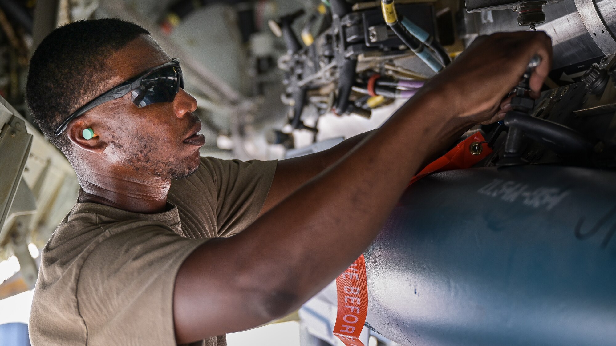 Staff Sgt. Schnathan Johnson, 96th Aircraft Maintenance Unit weapons load team chief, tightens a bolt of a GBU-12 munition during Combat Hammer at Barksdale Air Force Base, Louisiana, June 7, 2022. Combat Hammer was an exercise that encompassed end-to-end evaluations from units across the wing, assessing proficiency across the board. (U.S. Air Force photo by Senior Airman Jonathan E. Ramos)