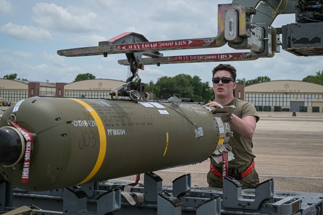 Airman 1st Class Marcus Macias, 96th Aircraft Maintenance Unit weapons load crew member, stabilizes a CBU-105 munition before pick up during Combat Hammer at Barksdale Air Force Base, Louisiana, June 7, 2022. A key mission objective of Combat Hammer was to evaluate the reliability, maintainability, sustainability, accuracy and readiness of complete fielded combat weapons systems against realistic threats and targets when employed by the operational Air Force. (U.S. Air Force photo by Senior Airman Jonathan E. Ramos)
