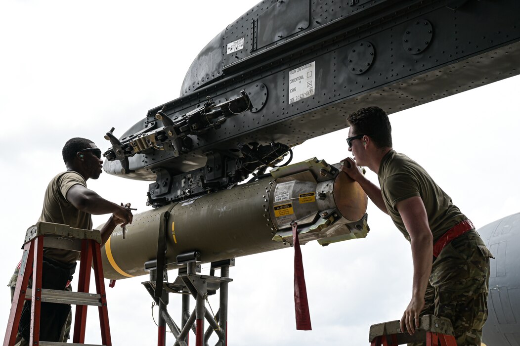 Staff Sgt. Schnathan Johnson, left, 96th Aircraft Maintenance Unit weapons load team chief, and Airman 1st Class Marcus Macias, right, 96th AMU weapons load crew member, load a CBU-105 munition to a B-52H Stratofortress during Combat Hammer at Barksdale Air Force Base, Louisiana, June 7, 2022. Airmen from the 96th AMU loaded and employed nearly 6 types of various munitions and flew a total of eight sorties in support of exercise Combat Hammer. (U.S. Air Force photo by Senior Airman Jonathan E. Ramos)