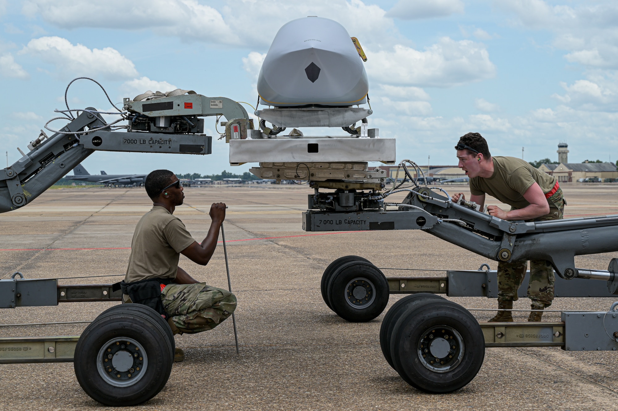 Staff Sgt. Schnathan Johnson, left, 96th Aircraft Maintenance Unit weapons load team chief, and Airman 1st Class Marcus Macias, right, 96th AMU weapons load crew member, verify a AGM-158 munition is properly tightened before being loaded onto a B-52H Stratofortress during Combat Hammer at Barksdale Air Force Base, Louisiana, June 7, 2022. Combat Hammer was an exercise that encompassed end-to-end evaluations from units across the wing, assessing proficiency across the board. (U.S. Air Force photo by Senior Airman Jonathan E. Ramos)