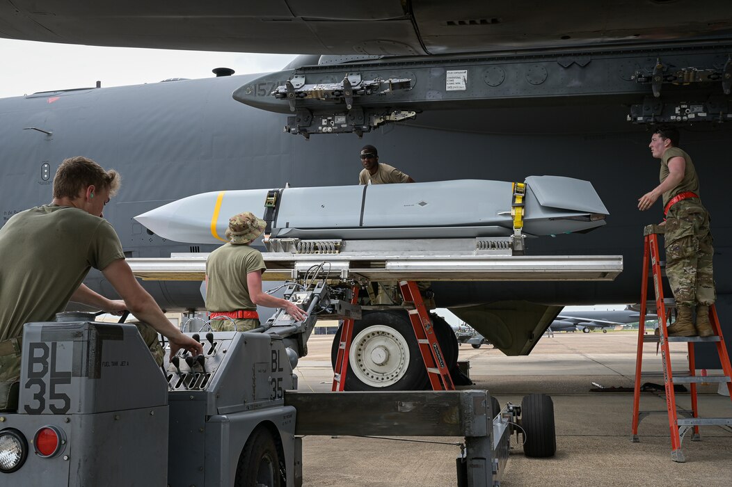 Airmen from the 96th Aircraft Maintenance Unit raise an AGM-158 munition onto a B-52H Stratofortress during Combat Hammer at Barksdale Air Force Base, Louisiana, June 7, 2022. A key mission objective of Combat Hammer was to evaluate the reliability, maintainability, sustainability, accuracy and readiness of complete fielded combat weapons systems against realistic threats and targets when employed by the operational Air Force. (U.S. Air Force photo by Senior Airman Jonathan E. Ramos)