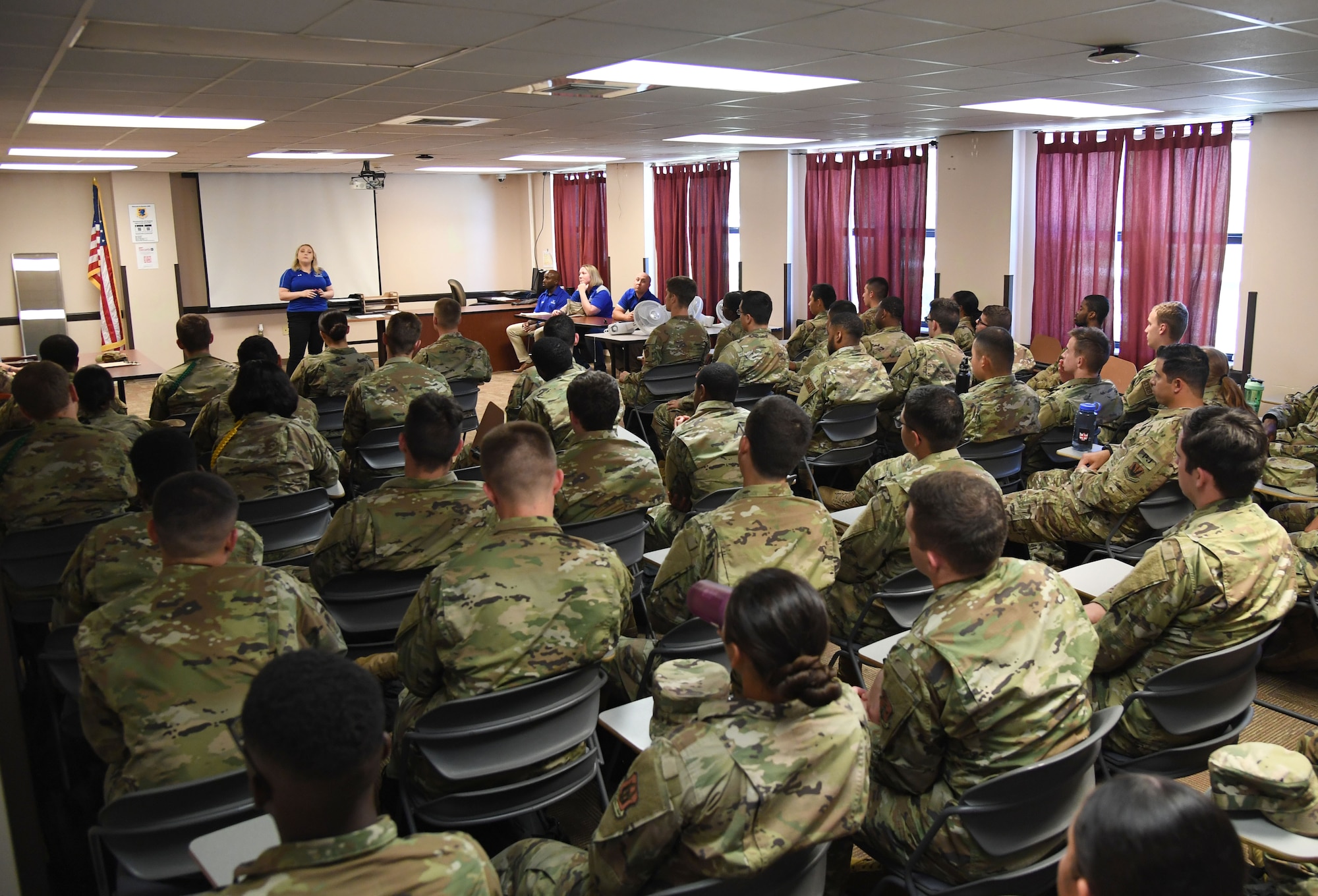 U.S. Air Force Retired Staff Sgt. Laura Flood, Air Force Wounded Warrior (AFW2) program ambassador, tells her story to students from the 336th Training Squadron inside Holbrook Manor at Keesler Air Force Base, Mississippi, June 7, 2022. The AFW2 program provides concentrated non-medical care and support for combat wounded, ill and injured Airmen and their families as they recover and transition back to duty or into civilian life. (U.S. Air Force photo by Kemberly Groue)