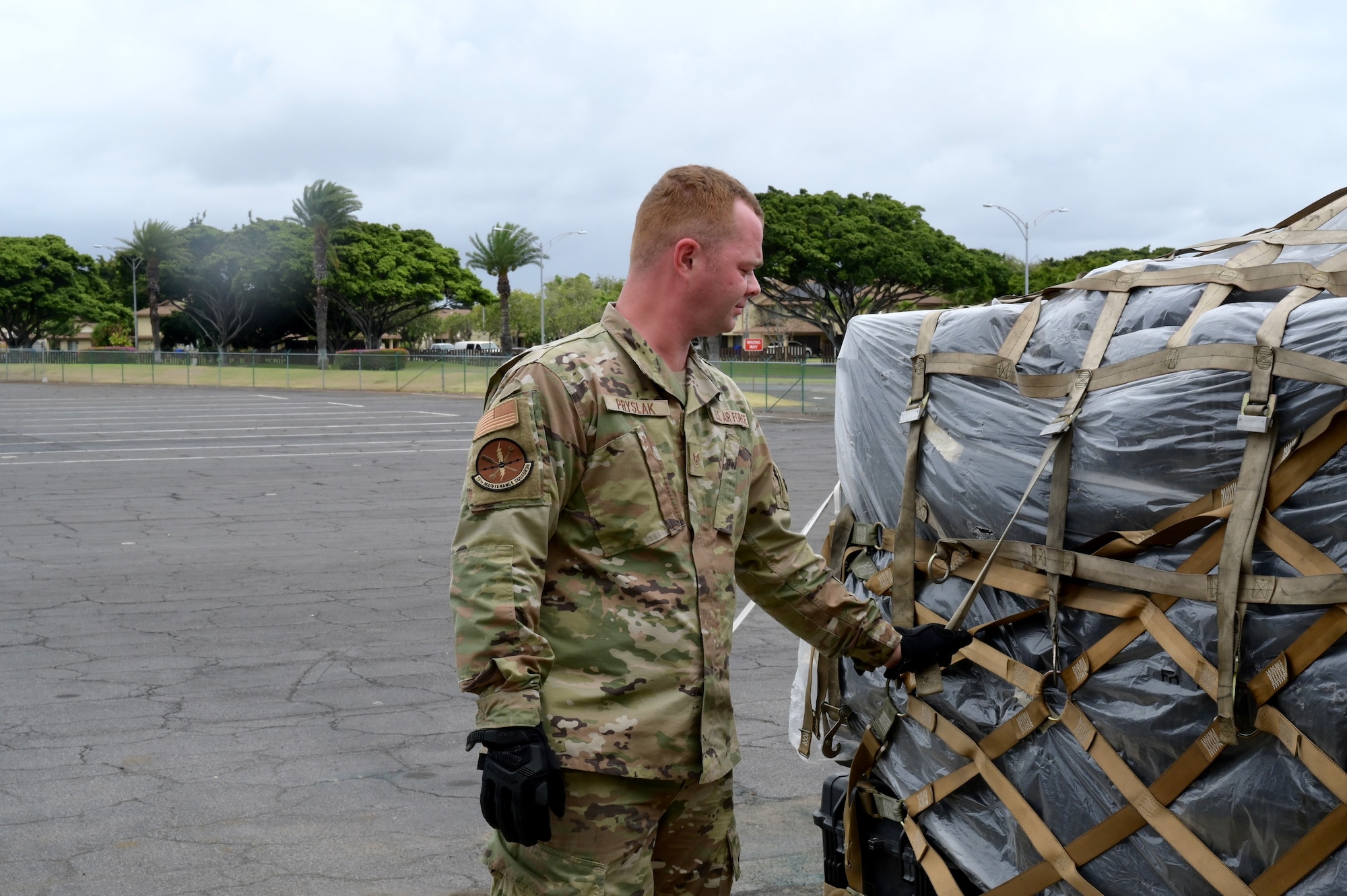 Staff Sgt. Christopher Pryslak, 15th Maintenance Squadron aerospace propulsion technician, checks to make sure the straps are secured on a simulated-cargo pallet during the 15th Wing’s Multi-Capable Airmen Tier 1 training event at Joint Base Pearl Harbor-Hickam, Hawaii, May 19, 2022. This event served as the 15th Wing’s first-ever MCA training event and involved Airmen from across JBPHH. (U.S. Air Force photo by 1st Lt. Benjamin Aronson)