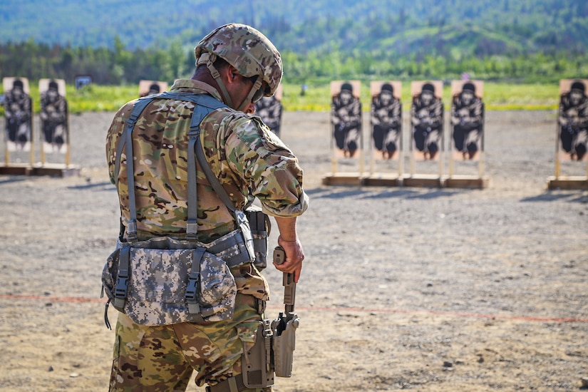 Spc. Nathan Alkines with the 207th Aviation Regiment holsters his SIG Sauer M17 handgun during the final pistol qualification table during the 2022 Alaska National Guard Adjutant General Match held at Joint Base Elmendorf-Richardson, Alaska, June 4, 2022. Soldiers and Airmen across the Alaska National Guard are competing in tests to become the next marksmanship champions of the annual TAG Match. (Alaska National Guard photo by Pvt. Caleb Lawhorne, 134th Public Affairs Detachment)