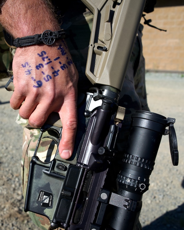 JOINT BASE ELMENDORF-RICHARDSON, Alaska – The hand of Alaska Air National Guard Tech. Sgt. Shawn Carter, 212th Rescue Squadron Combat Arms Training and Maintenance instructor, shows data on previous engagements, or DOPE, June 1, 2022, at Joint Base Elmendorf-Richardson during Alaska’s 2022 The Adjutant General Match. Teams of four service members competed throughout the week in a series of combat pistol and rifle marksmanship tests for a spot on the Governor’s Twenty marksmanship team. (Alaska Air National Guard photo by David Bedard)