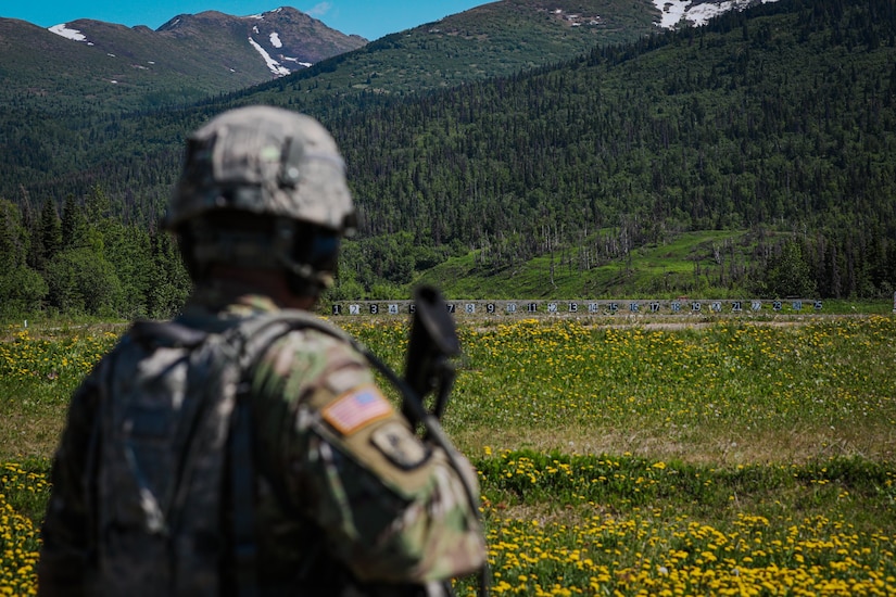 An Alaska Army National Guardsman looks down range before competing in a rifle marksmanship event during the 2022 Alaska National Guard Adjutant General's Match held at Joint Base Elmendorf-Richardson, Alaska, June 2, 2022. Eighteen teams competed in this year’s TAG Match to earn their place on the Governor’s Twenty marksmanship team. (Alaska National Guard photo by Pvt. Caleb Lawhorne, 134th Public Affairs Detachment)