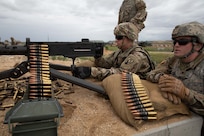 Pfc. Ryder Koon, a combat engineer from the 833rd Engineer Company, Iowa National Guard, fires a .50-caliber machine gun while Spc. Shawn Swanson spots targets during Western Strike 22, June 5, 2022, at Orchard Combat Training Center, Idaho.