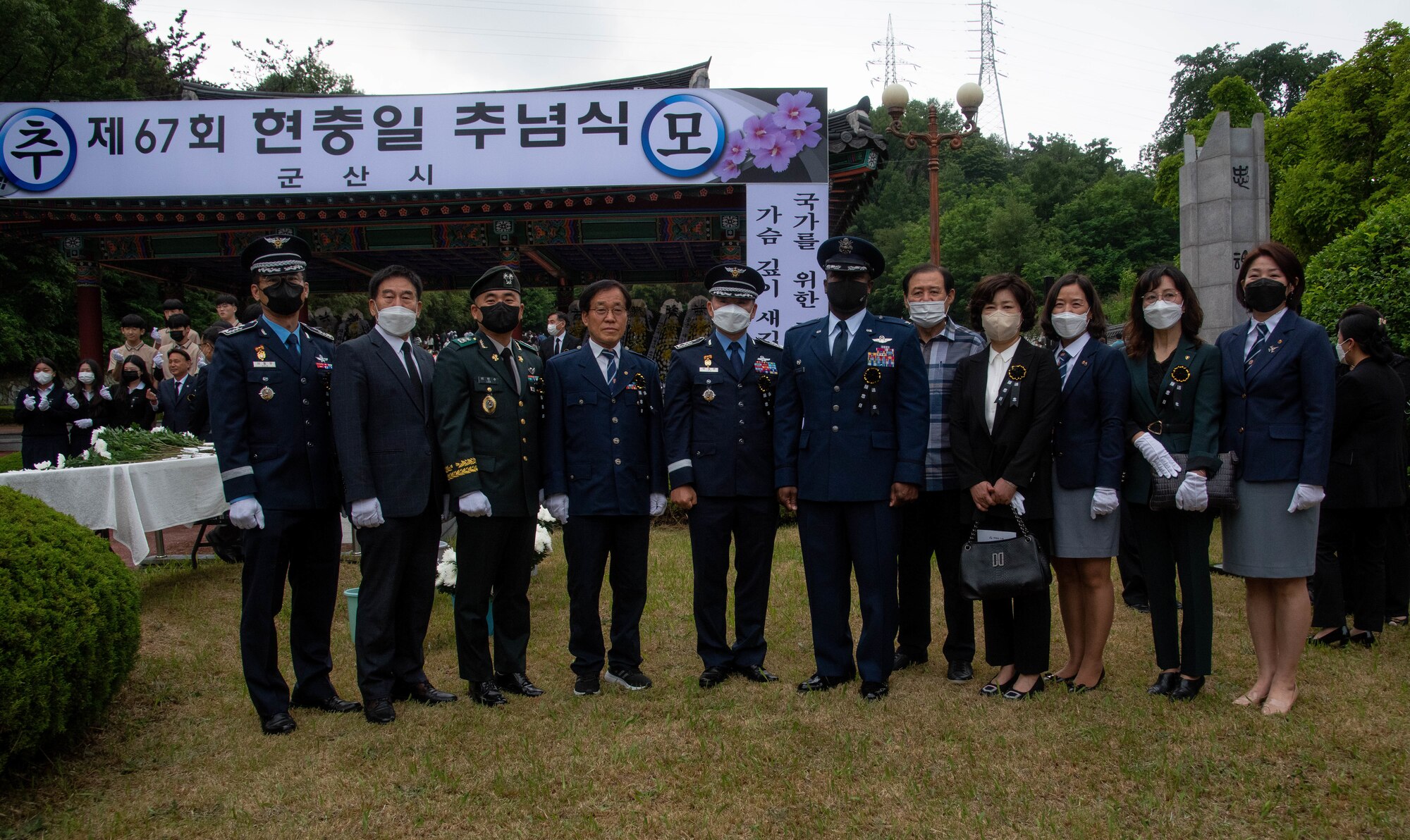Military members and government officials pose for a photo