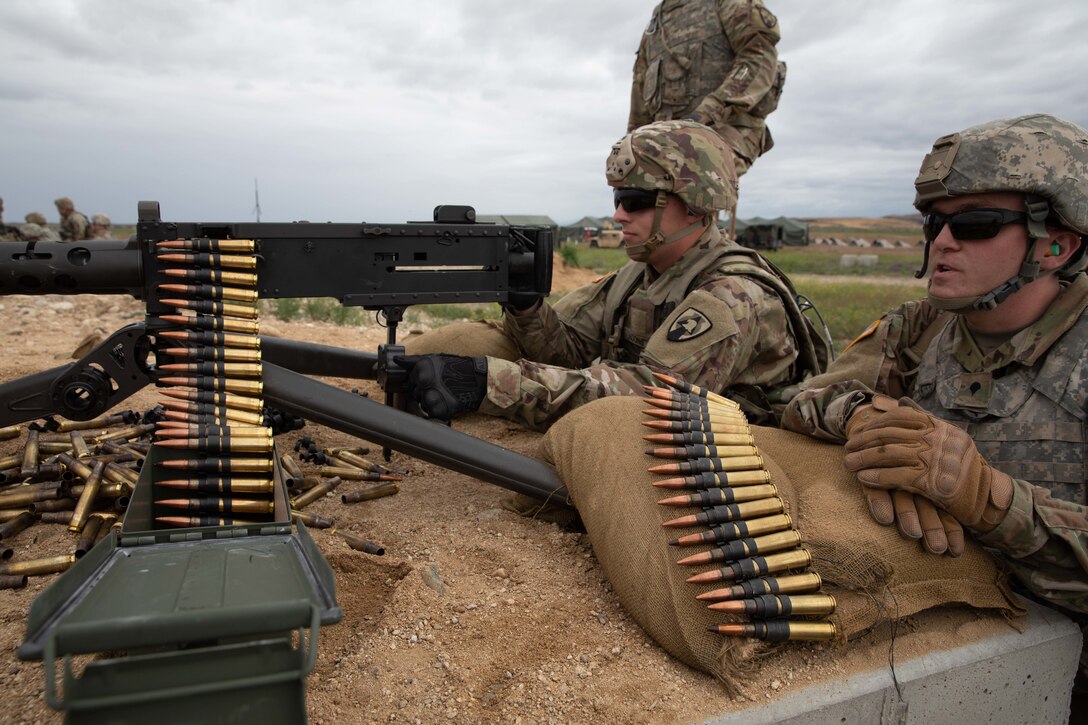 Pfc. Ryder Koon, a combat engineer from the 833rd Engineer Company, Iowa National Guard, fires a .50-caliber machine gun while Spc. Shawn Swanson spots targets during Western Strike 22, June 5, 2022, at Orchard Combat Training Center, Idaho.