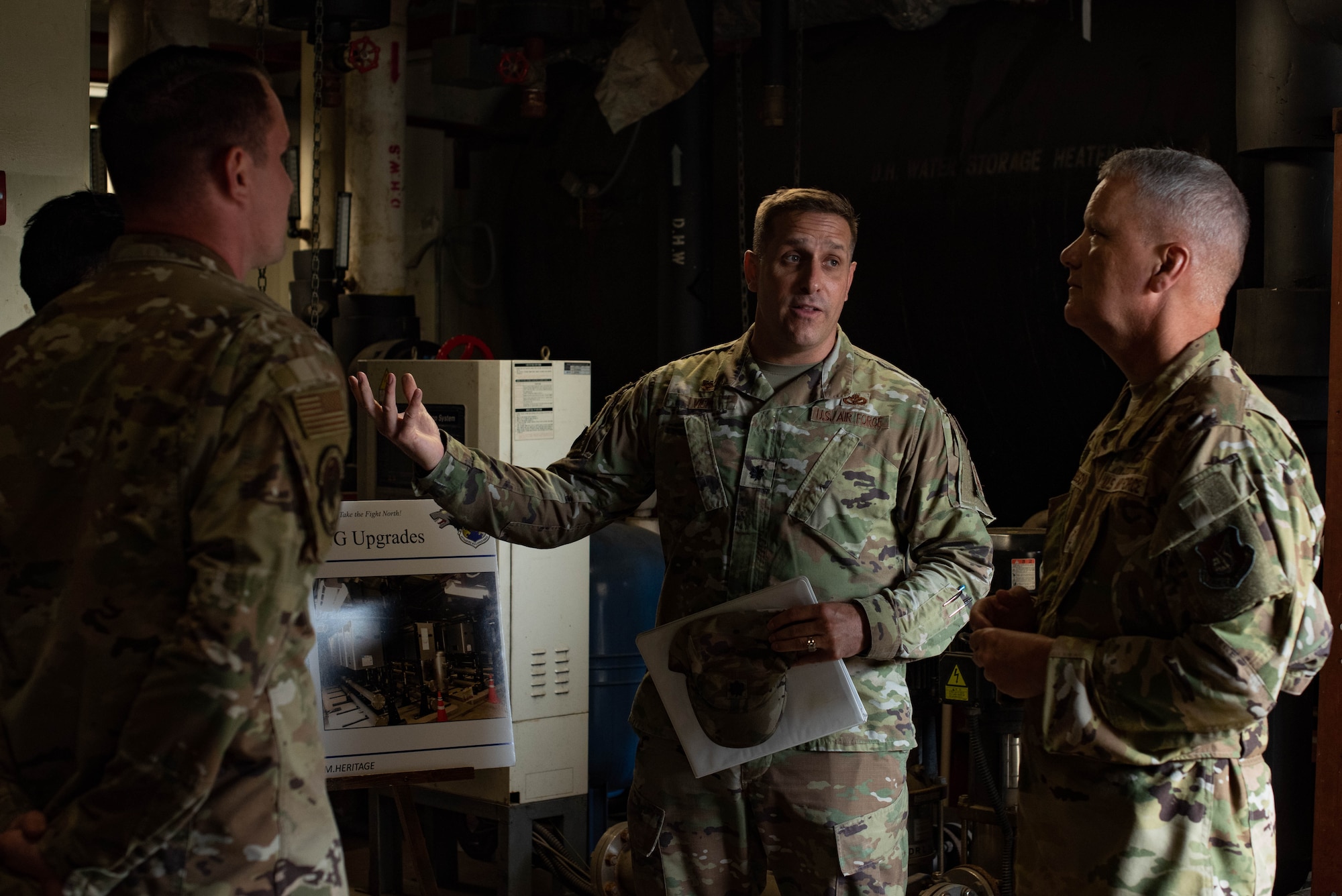 Three military members have a discussion.