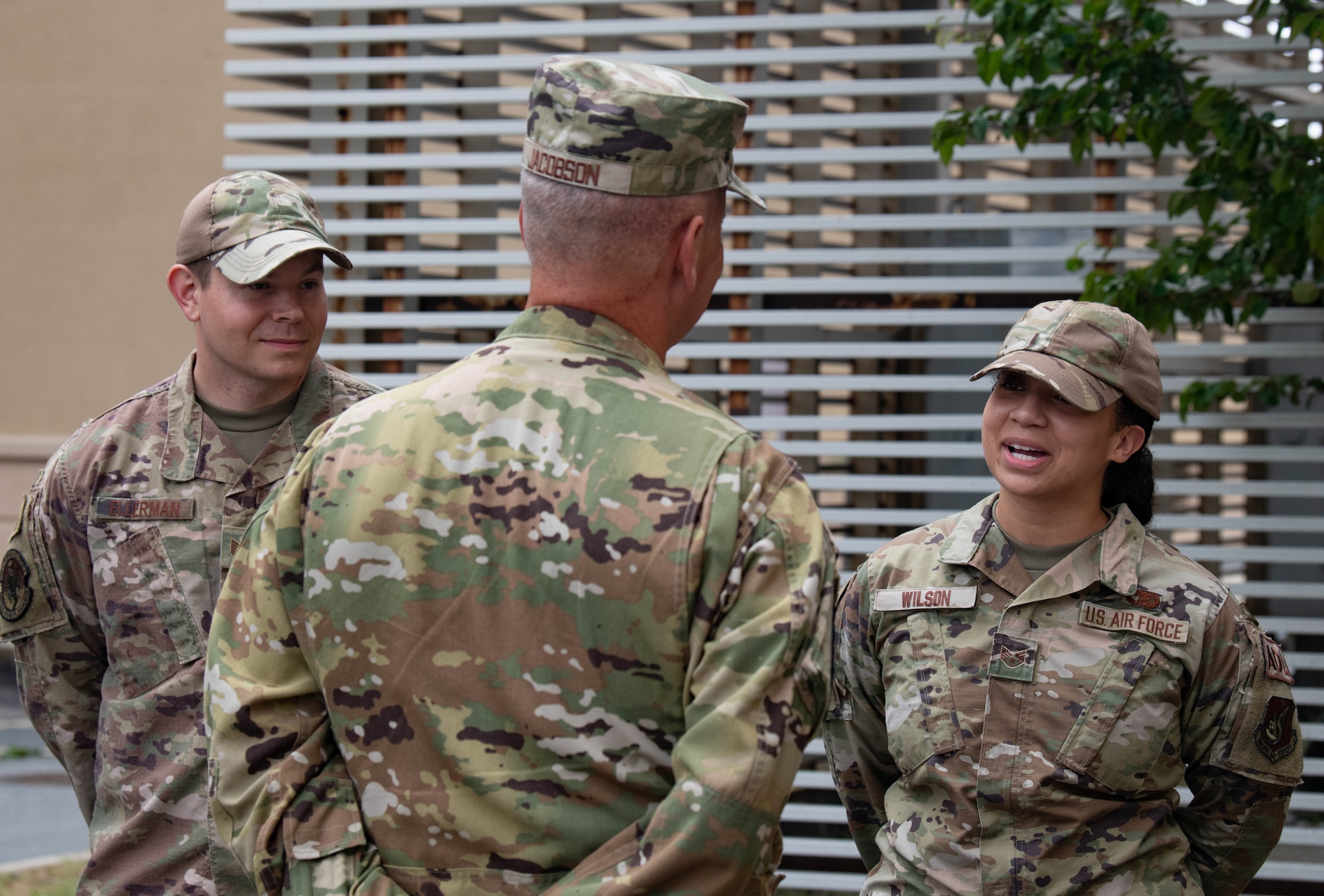 Three military members have a discussion.
