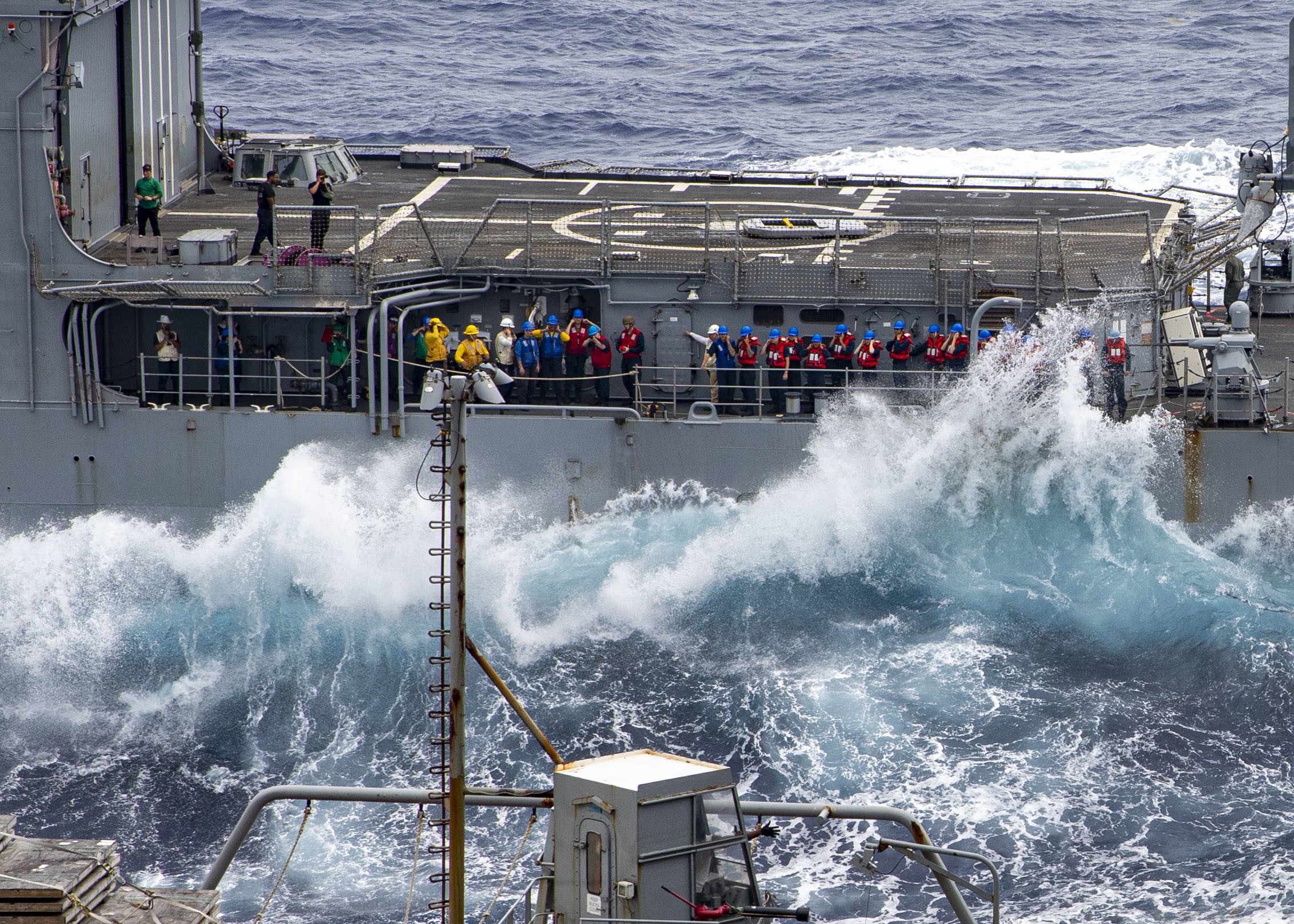 Sailors prepare to shoot line during a replenishment-at-sea with the Military Sealift Command fleet replenishment oiler USNS Leroy Grumman (T-AO 195), June 5, 2022.