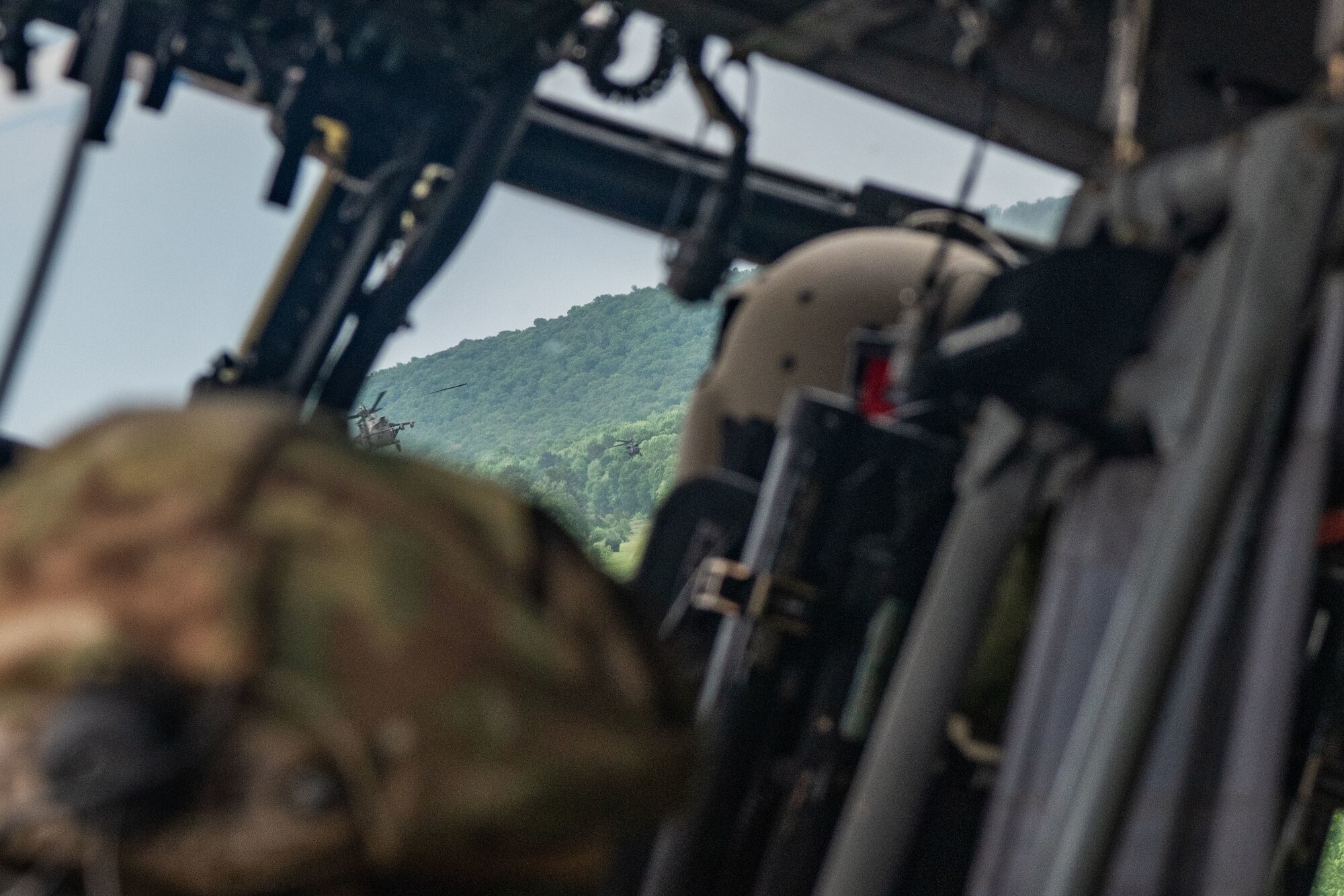 three helicopters flying