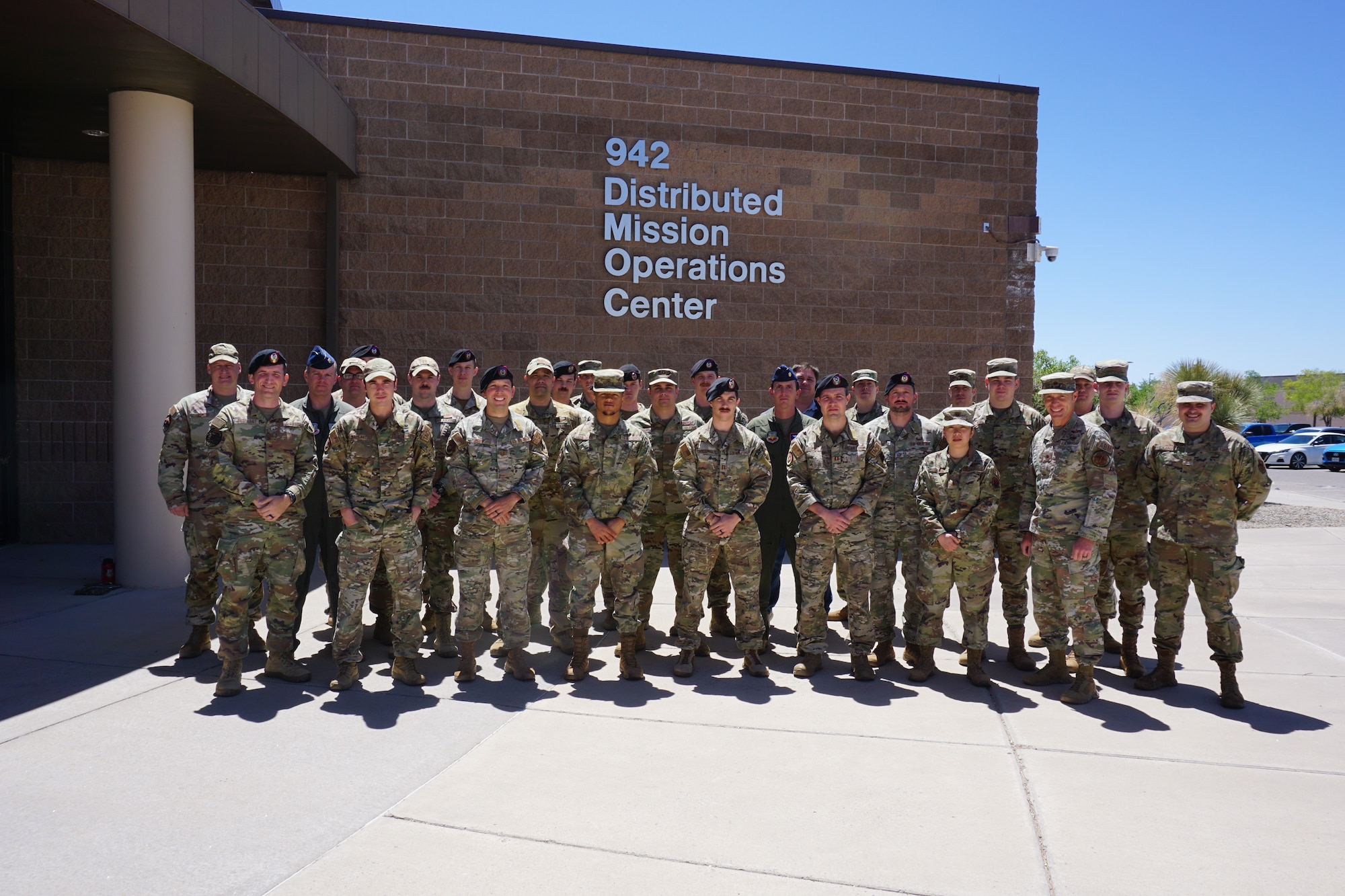 photo of large group of USAF Airmen standing in front of building