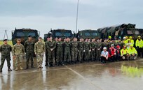 More than 25 Polish high school students from the Stanislaw Mikolajczyk Economic and Technical School in Paslek, Poland, and their instructors pose for a photo with Army Field Support Battalion-Mannheim personnel at an Equipment Configuration and Hand-off Area in Braniewo, Poland. The students were afforded the opportunity to see, touch and learn about the 405th Army Field Support Brigade’s Army Prepositioned Stocks-2 sets at the ECHA site following DEFENDER-Europe 22. (photo by Cpt. Aaron Carpenter)