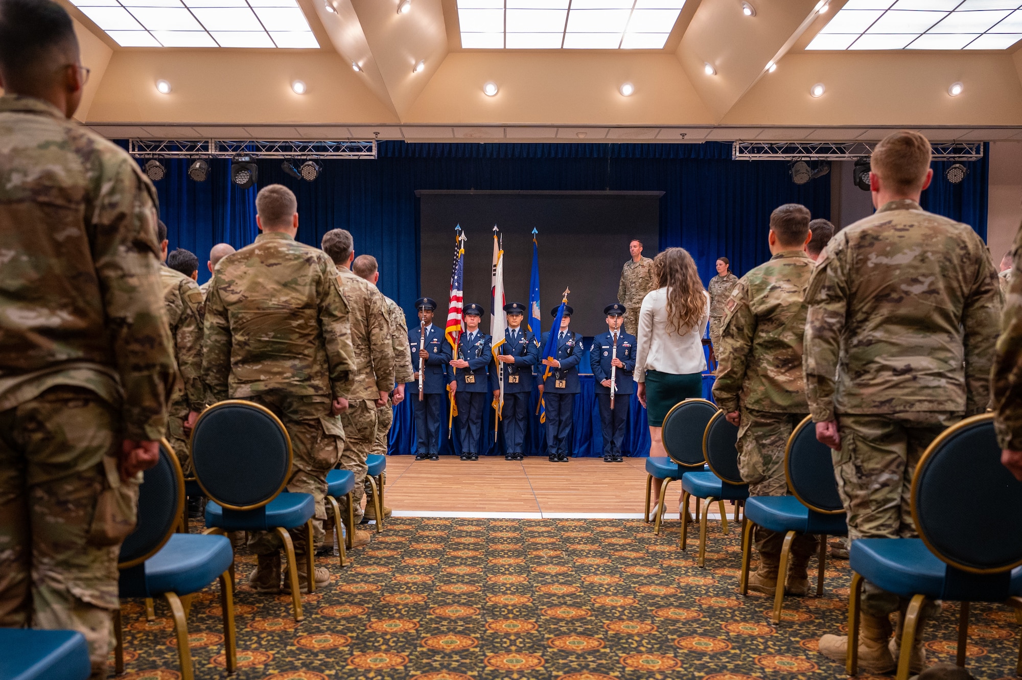 Members of the 607th Combat Weather Squadron (CWS) stand at attention for the playing of the U.S. National Anthem during the 607th CWS) Assumption of Command ceremony