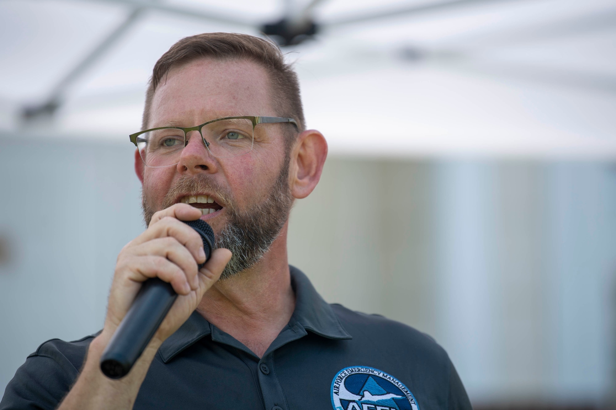 Arnie Maas, 436th Civil Engineer Squadron emergency management specialist, provides comments about the upcoming hurricane season during the 2022 Hurricane Block Party at Dover Air Force Base, Delaware, June 2, 2022. The block party, sponsored by the 436th CES Emergency Management flight, offered attendees useful information pertaining to severe storms and hurricanes. Additionally, attendees toured several booths set up by local organizations and base units, offering free gifts and information. (U.S. Air Force photo by Tech. Sgt. J.D. Strong II)