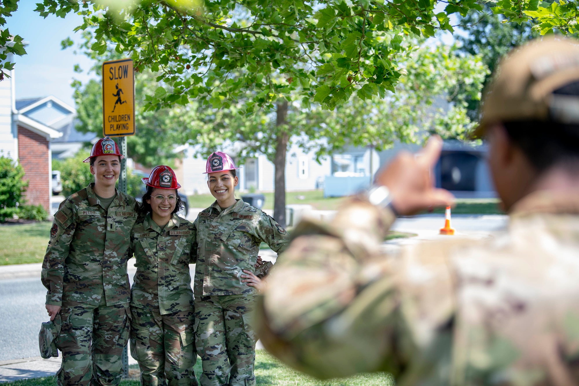 From the left, 1st Lt. Rebecca Pettit, 436th Airlift Wing chaplain, Airman 1st Class Thaliah Lopez, 436th Civil Engineer Squadron emergency management apprentice and Senior Airman Ashley Nicholas, 436th CES emergency management journeyman, pose for a photo during the 2022 Hurricane Block Party at Dover Air Force Base, Delaware, June 2, 2022. The block party, sponsored by the 436th CES Emergency Management flight, offered attendees useful information pertaining to severe storms and hurricanes. Additionally, attendees toured several booths set up by local organizations and base units, offering free gifts and information. (U.S. Air Force photo by Tech. Sgt. J.D. Strong II)