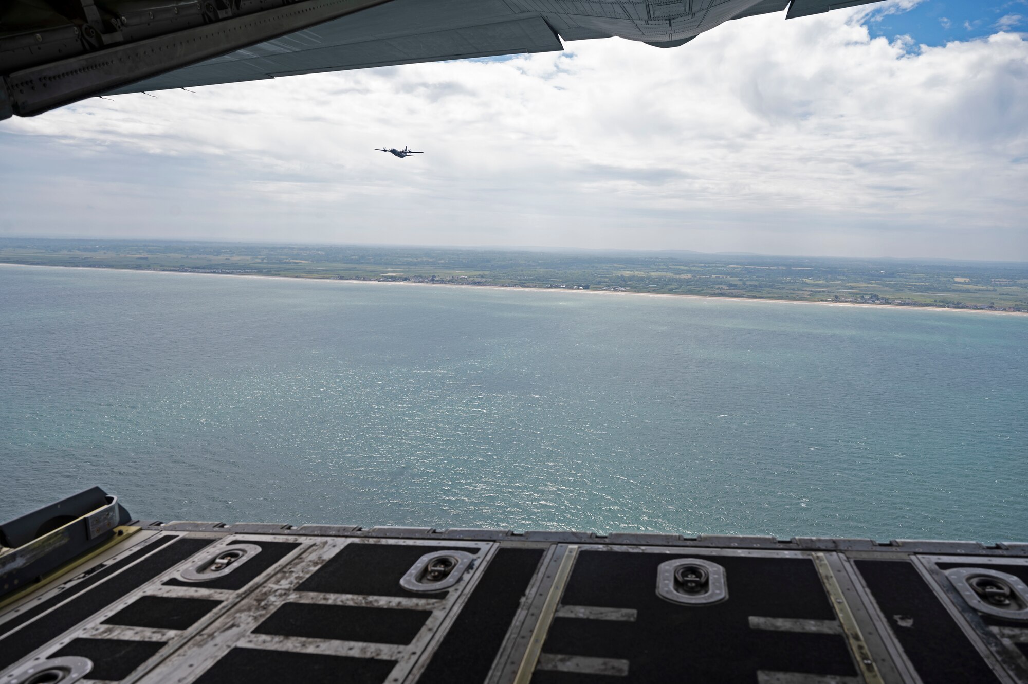 Two C-130J Super Hercules aircraft assigned to the 37th Airlift Squadron out of Ramstein Air Base, Germany, fly over the beaches of Normandy, France during a ceremony, June 2, 2022. The 37th AS participated in the 78th Annual D-Day memorial as a way to pay tribute to the British, Canadian and U.S. forces who stormed the beaches and parachuted into Normandy on June 6, 1944. (U.S. Air Force photo by Senior Airman Thomas Karol)