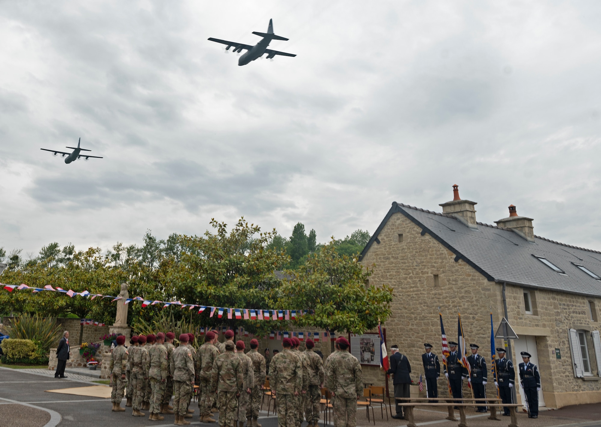 Two C-130J Super Hercules aircraft out of Ramstein Air Base, Germany, fly over Negreville, France during a D-Day ceremony June 3, 2022. On June 6, 1944 a Douglas C-47 Skytrain aircraft crashed near Negreville after being hit by anti-aircraft fire and all aircrew members and paratroopers were forced to jump 12 miles away from their intended drop zone. (U.S. Air Force photo by Senior Airman Thomas Karol)