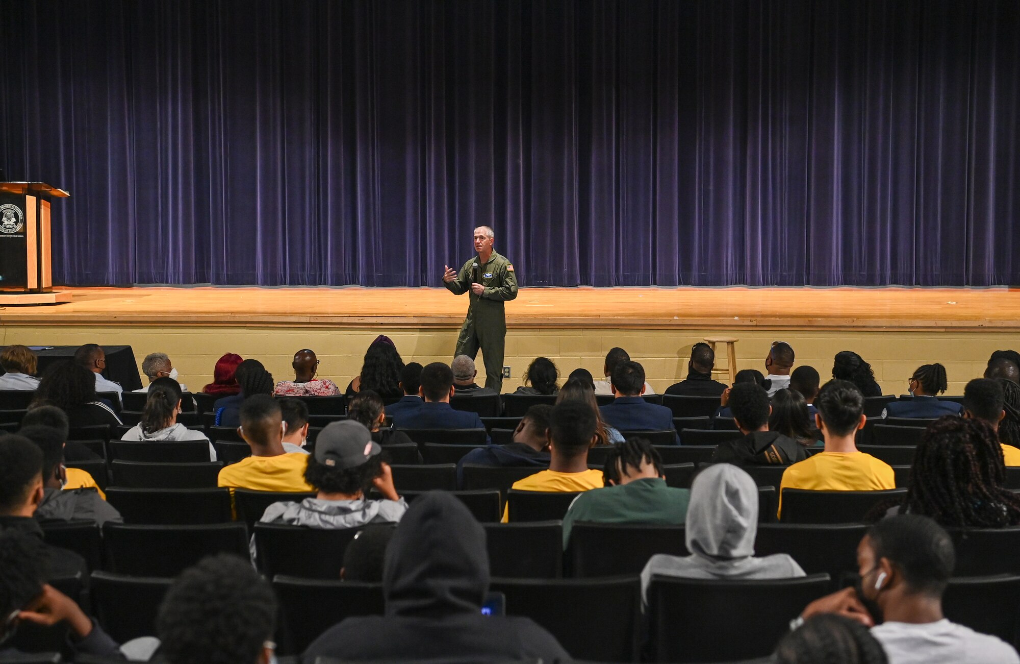 Man in uniform speaks to group