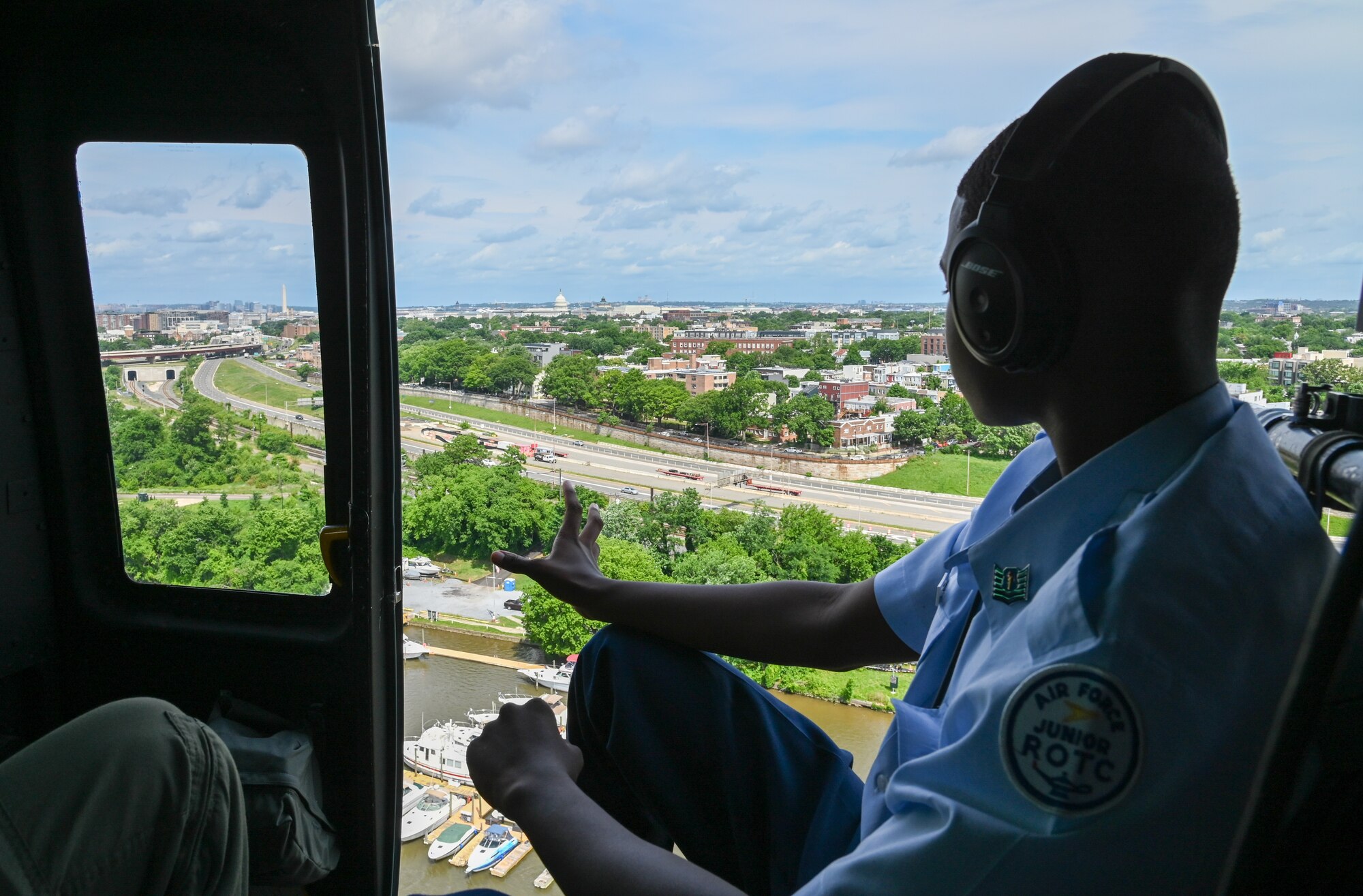 ROTC cadet looks at ground from helicopter