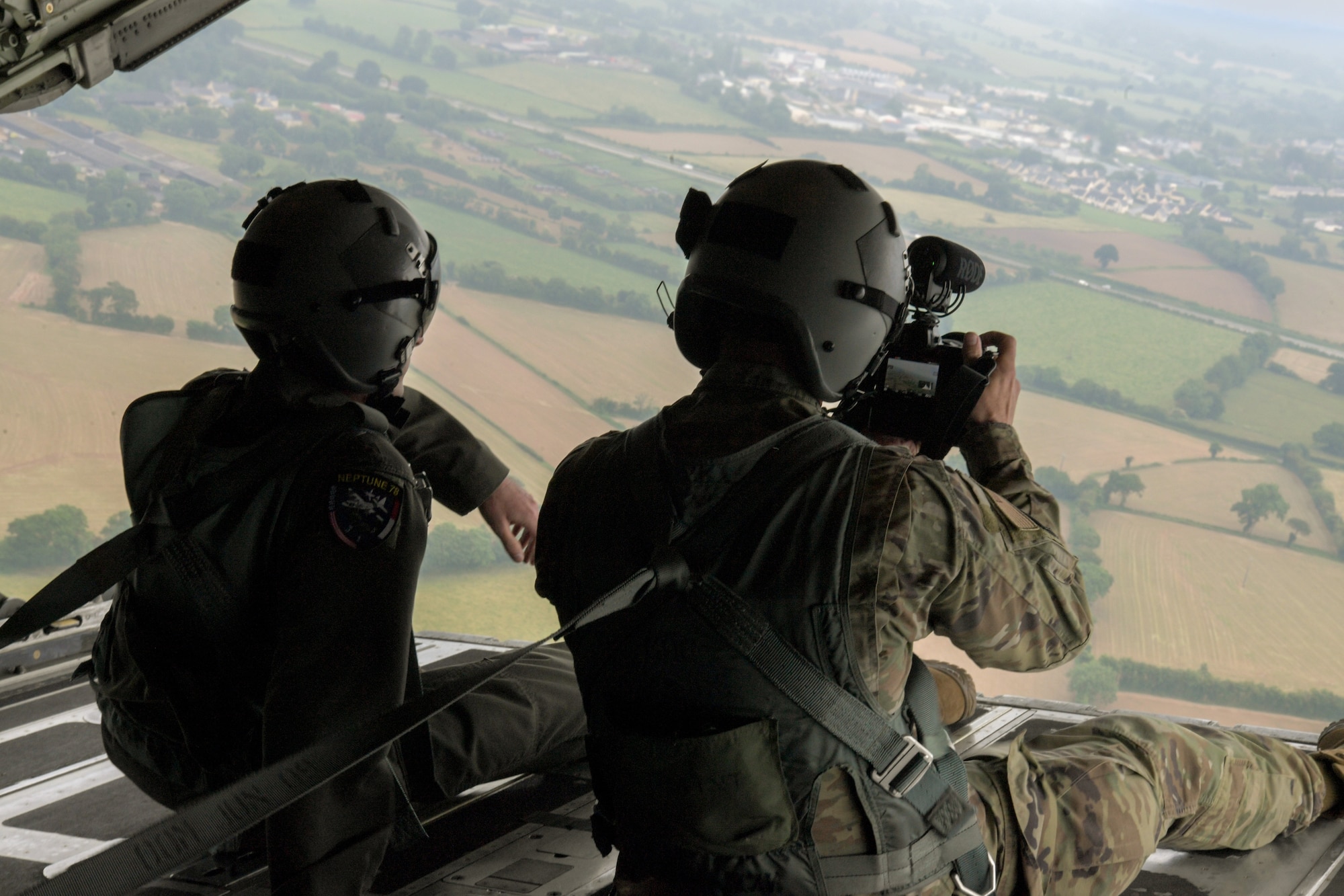 U.S. Air Force Senior Airman John Wright (right), 86th Airlift Wing public affairs journeyman, records footage of a flyover demonstration in Normandy, France, June 3, 2022. The 37th Airlift Squadron out of Ramstein Air Base, Germany, participated in multiple memorial ceremonies and demonstrations to pay tribute to those who lost their lives on D-Day 78 years ago. (U.S. Air Force photo by Airman 1st Class Lauren Jacoby)