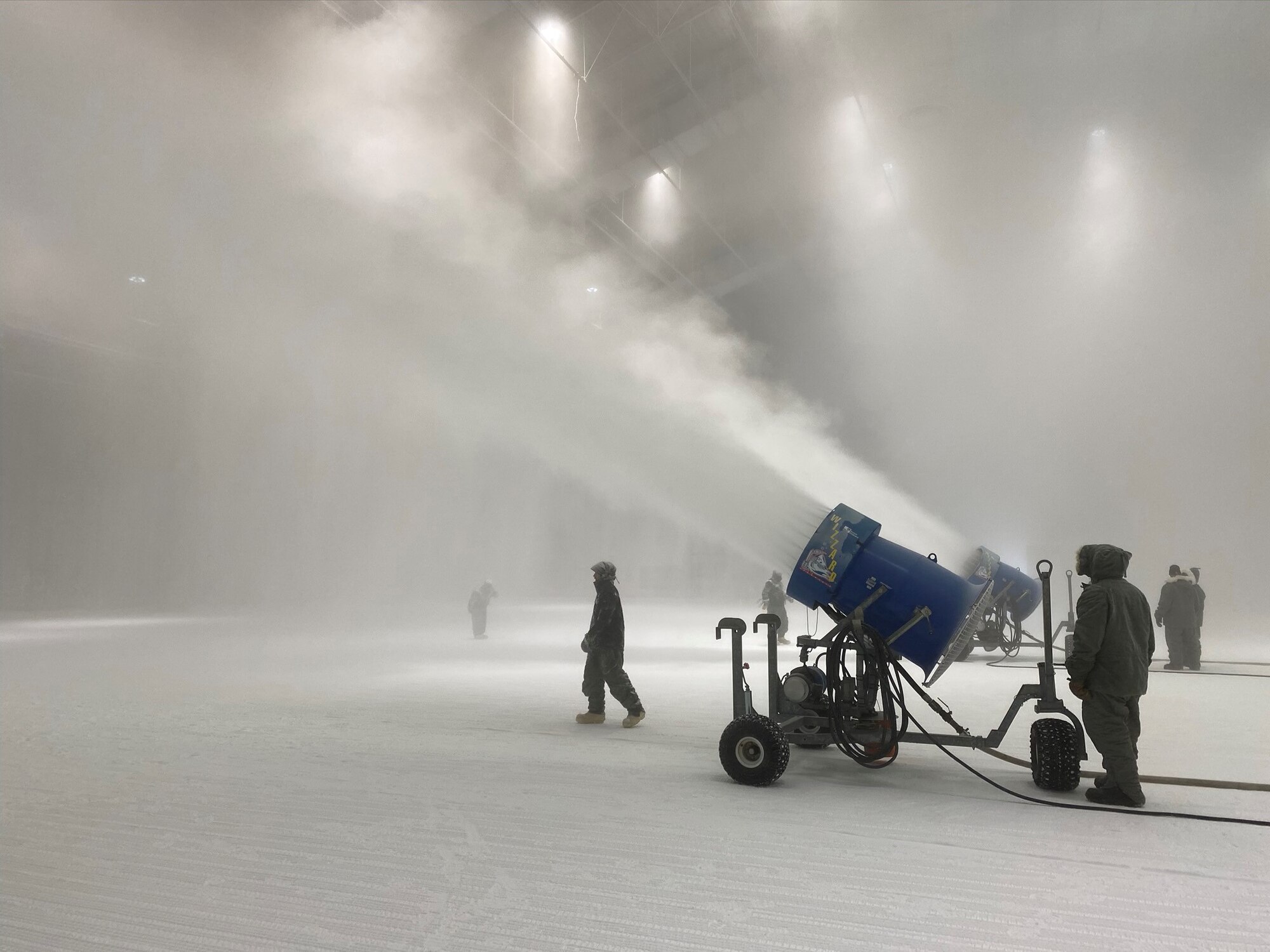 Team members at the McKinley Climatic Laboratory at Eglin Air Force Base, Florida, use machines to create snow in the MCL Main Chamber to prepare for environmental testing. Those at the MCL recently celebrated the 75th anniversary of the facility. The first tests at the MCL occurred in May 1947. The MCL is operated by the 717th Test Squadron, 804th Test Group, Arnold Engineering Development Complex. (U.S. Air Force photo by William Higdon)