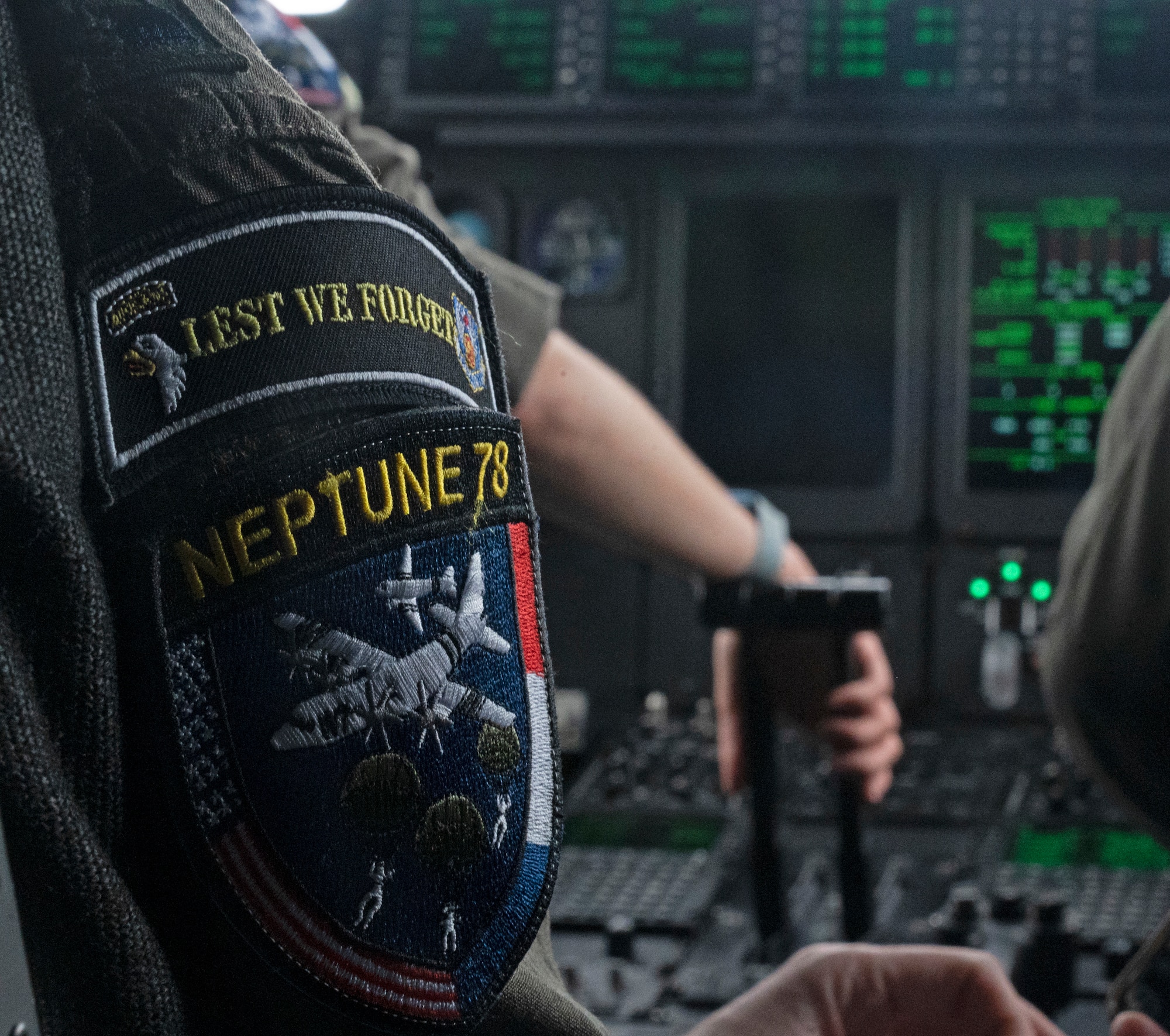 U.S. Air Force Capt. Sam Schell, 37th Airlift Squadron pilot, displays a Neptune 78 and 101st Airborne commemorative patch at Normandy, France, June 4, 2022. The 37 AS came to Normandy to participate in fly overs for events and to drop paratroopers on historic locations as soldiers and Airmen did 78 years ago during World War II. (U.S. Air Force photo by Senior Airman Thomas Karol)