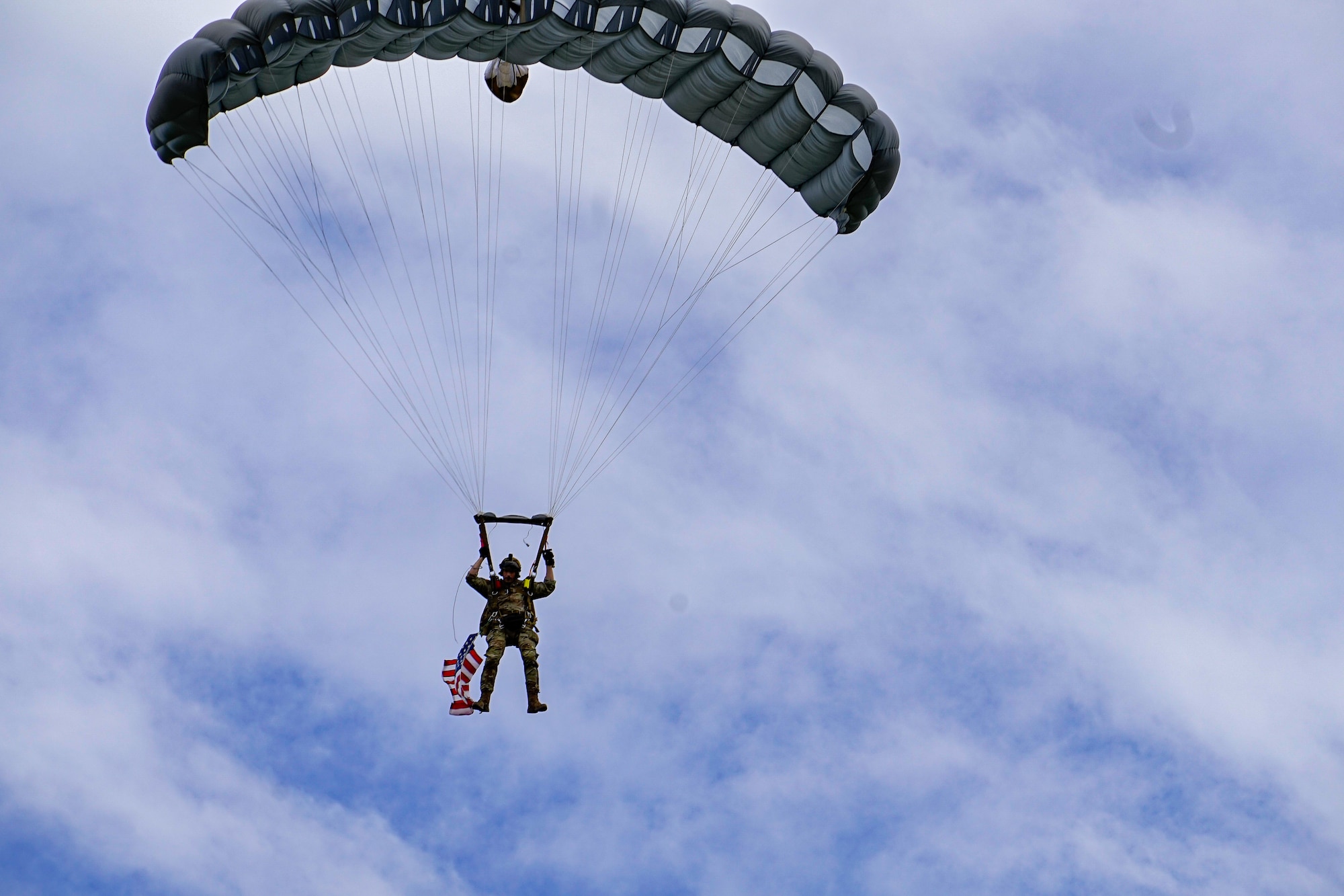 A U.S. Army Airborne soldier glides into a drop zone in Normandy, France, June 5, 2022. The soldiers landed in the same area the Germans purposely flooded during World War II in an attempt to defeat U.S. Forces. (U.S. Air Force photo by Airman 1st Class Lauren Jacoby)